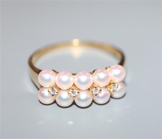 A modern Mikimoto 18ct gold, ten cultured pearl and four stone diamond set half hoop dress ring, size Q.